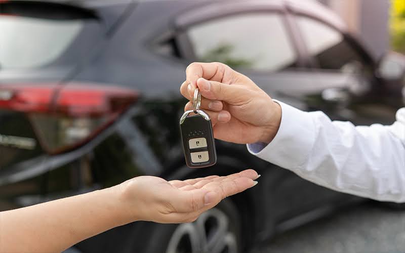 Hand Over Of Car Keys From Dealer To Customer